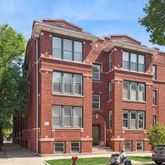 a front view of a residential apartment building with a yard