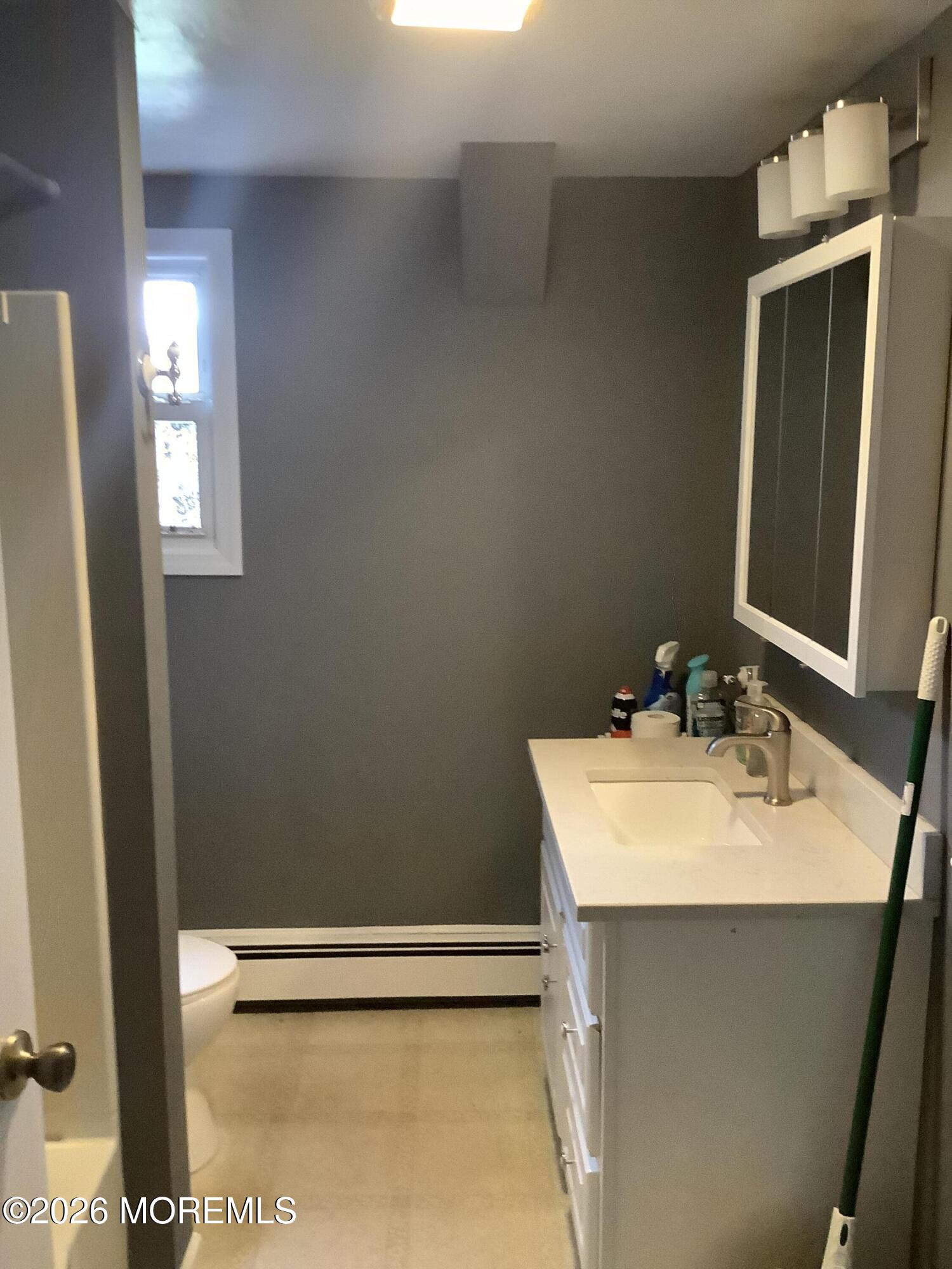 242 1st Street Keyport, NJ 07735 - Photo 23 of 23 a bathroom with a sink a vanity and a mirror