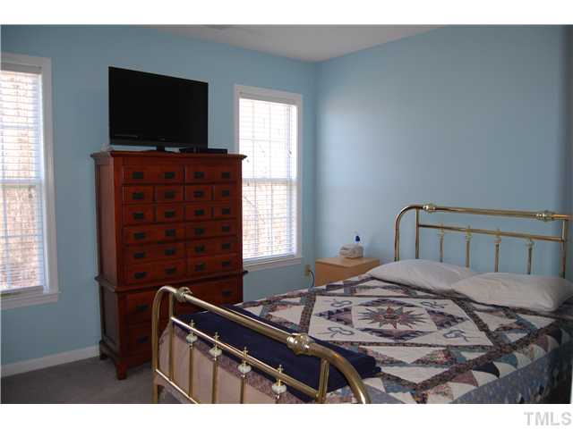 8520 Ridgebury Road Raleigh, NC 27603 - Photo 15 of 22 a bedroom with a bed and a flat screen tv