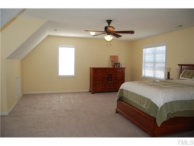 8520 Ridgebury Road Raleigh, NC 27603 - Photo 18 of 22 a bedroom with a bed dresser and a window