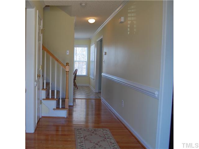 8520 Ridgebury Road Raleigh, NC 27603 - Photo 2 of 22 a view of a hallway with wooden floor