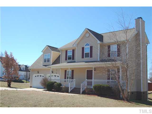 8520 Ridgebury Road Raleigh, NC 27603 - Photo 21 of 22 a view of a big house with a big yard and large tree