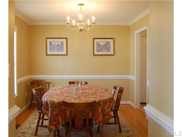 8520 Ridgebury Road Raleigh, NC 27603 - Photo 3 of 22 a view of a dining room with furniture and chandelier