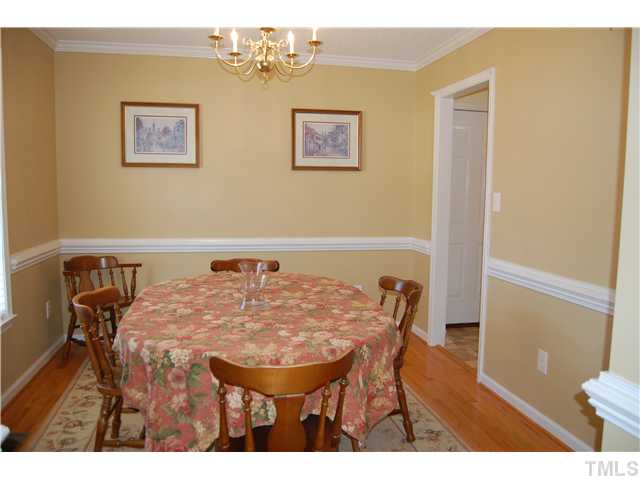 8520 Ridgebury Road Raleigh, NC 27603 - Photo 4 of 22 a view of a dining room with furniture and wooden floor