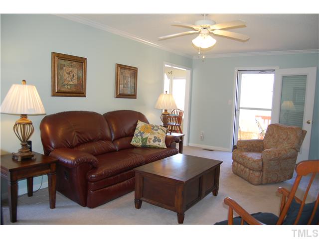 8520 Ridgebury Road Raleigh, NC 27603 - Photo 7 of 22 a living room with furniture a chandelier and a window