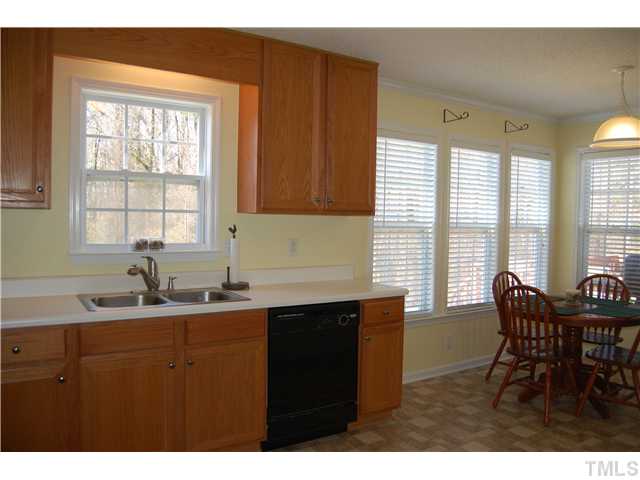 8520 Ridgebury Road Raleigh, NC 27603 - Photo 9 of 22 a kitchen with granite countertop a sink cabinets and dining table