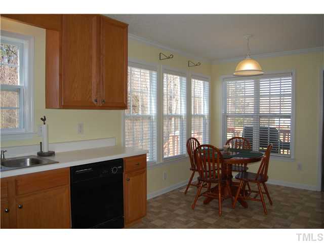8520 Ridgebury Road Raleigh, NC 27603 - Photo 10 of 22 a view of a dining room with furniture and chandelier
