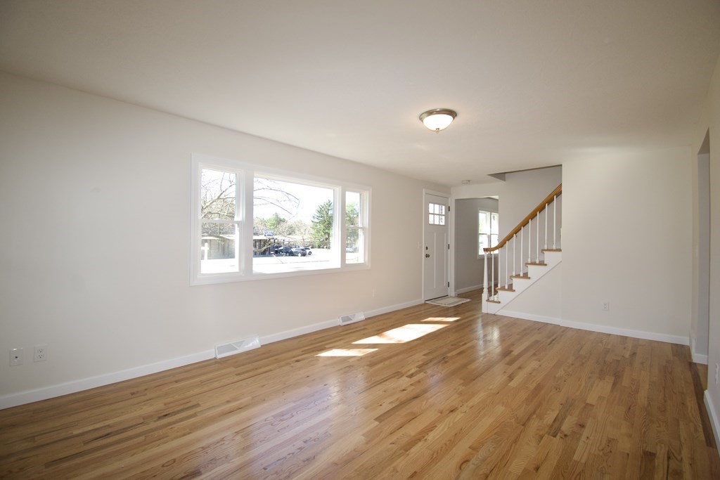 812 Maple Road Longmeadow, MA 01106 - Photo 5 of 22 a view of an empty room with wooden floor and a window