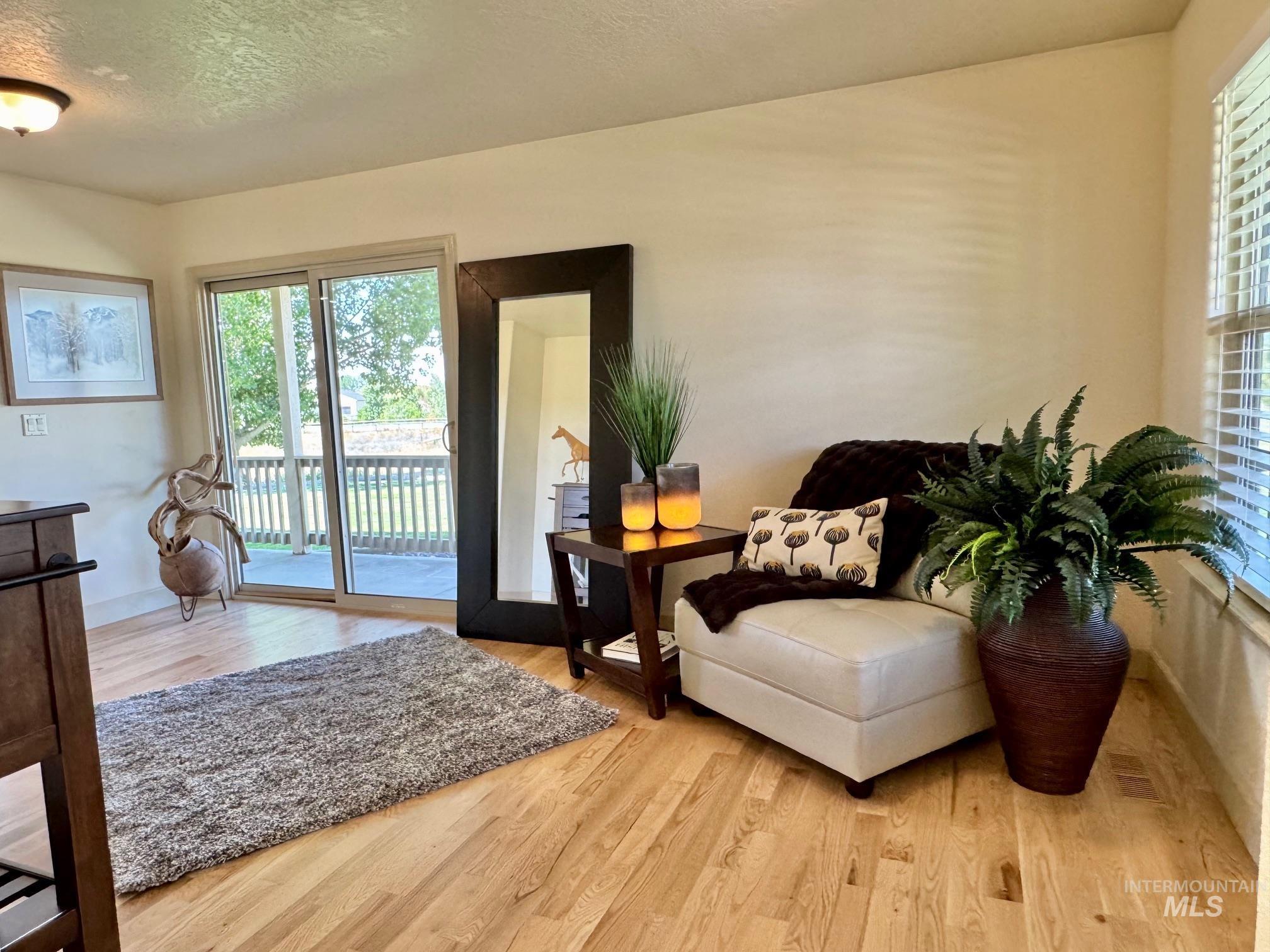 9299 Kemp Road Middleton, ID 83644 - Photo 20 of 50 Light wood-finish flooring provides a bright foundation for this interior space featuring a sliding glass door to an outdoor deck