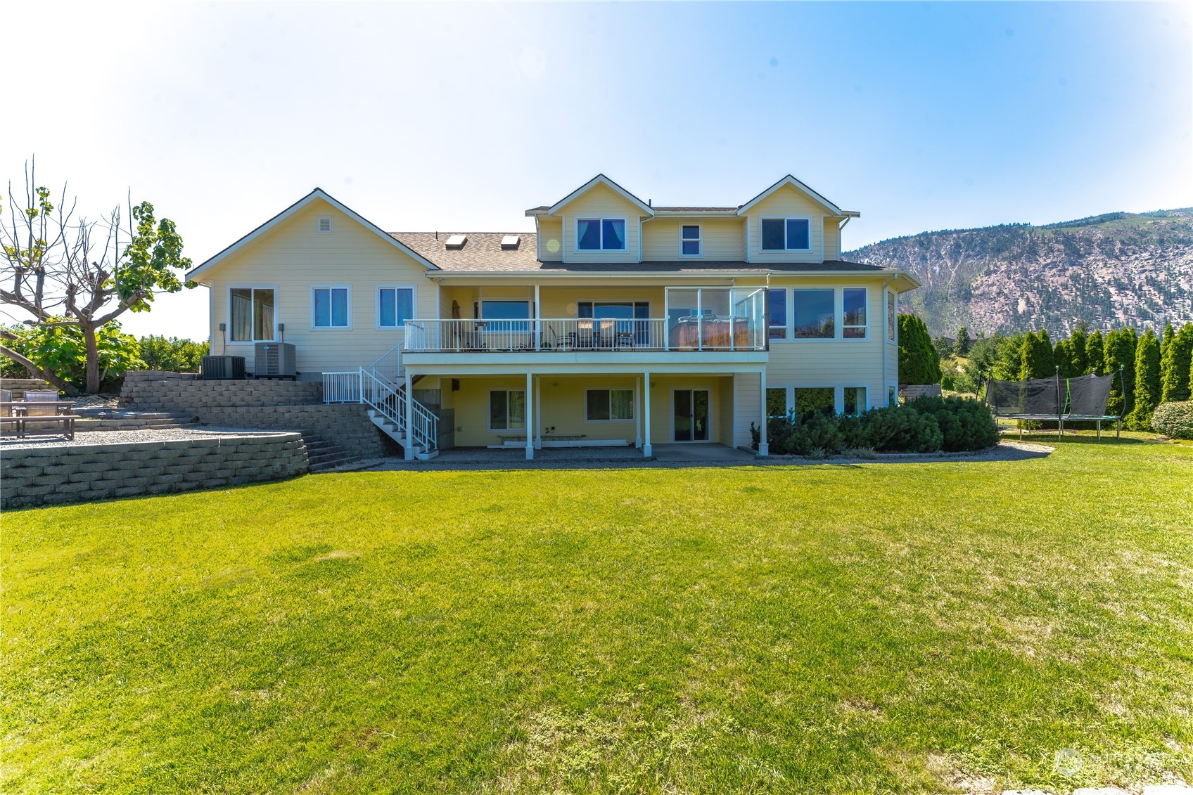 900 Loop Avenue Manson, WA 98831 - Photo 11 of 40 a front view of a house with a yard and garage
