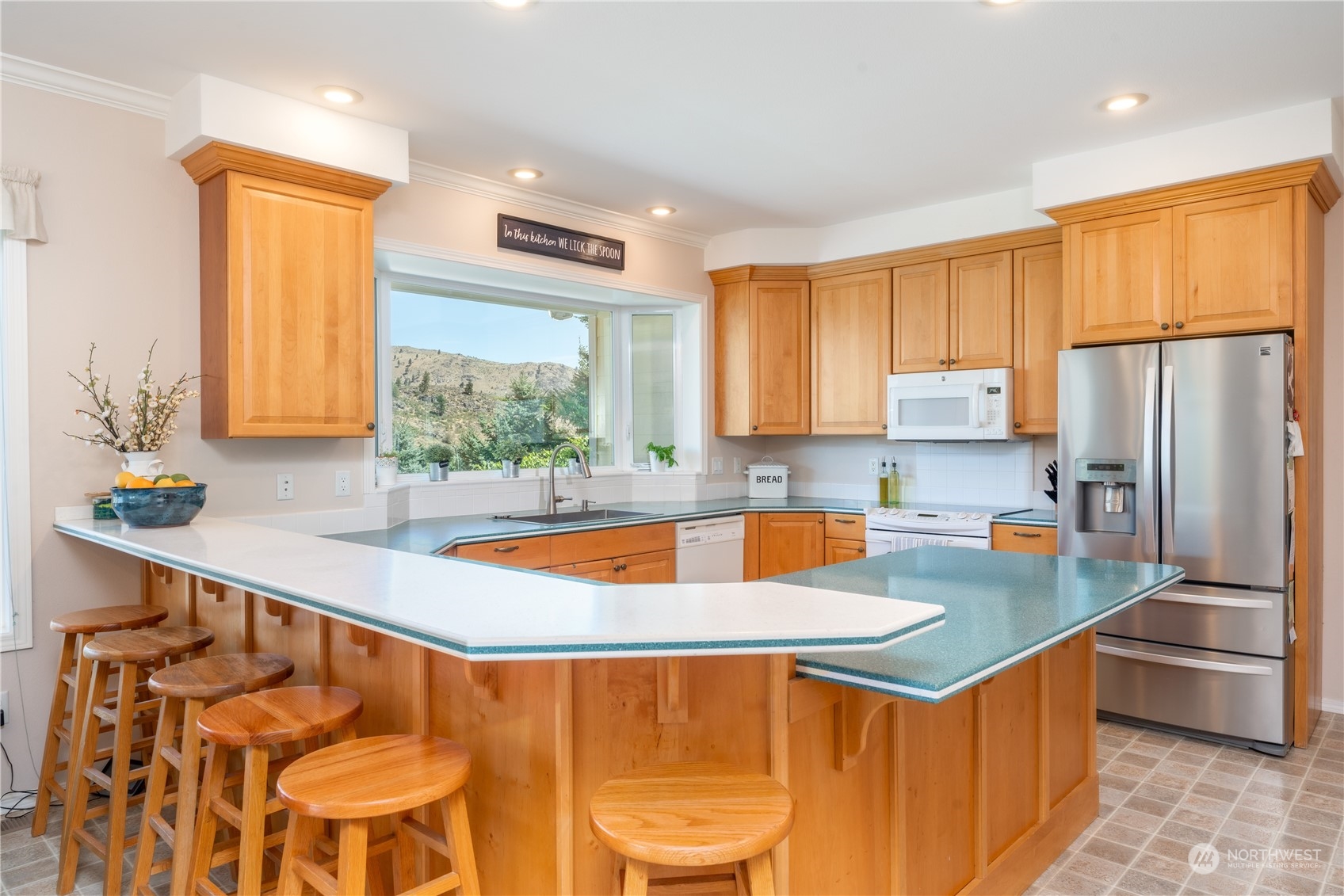 900 Loop Avenue Manson, WA 98831 - Photo 18 of 40 a kitchen with stainless steel appliances granite countertop a sink a stove and refrigerator