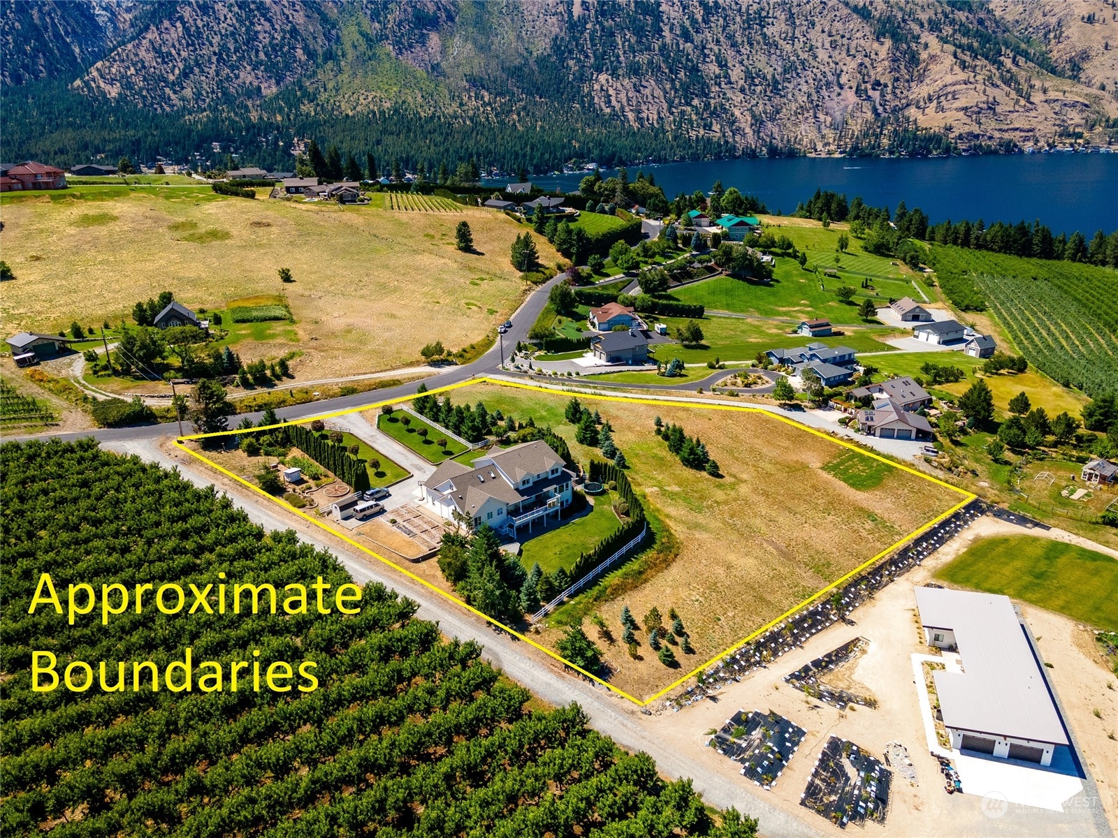 900 Loop Avenue Manson, WA 98831 - Photo 2 of 40 a view of a swimming pool with a patio and a yard