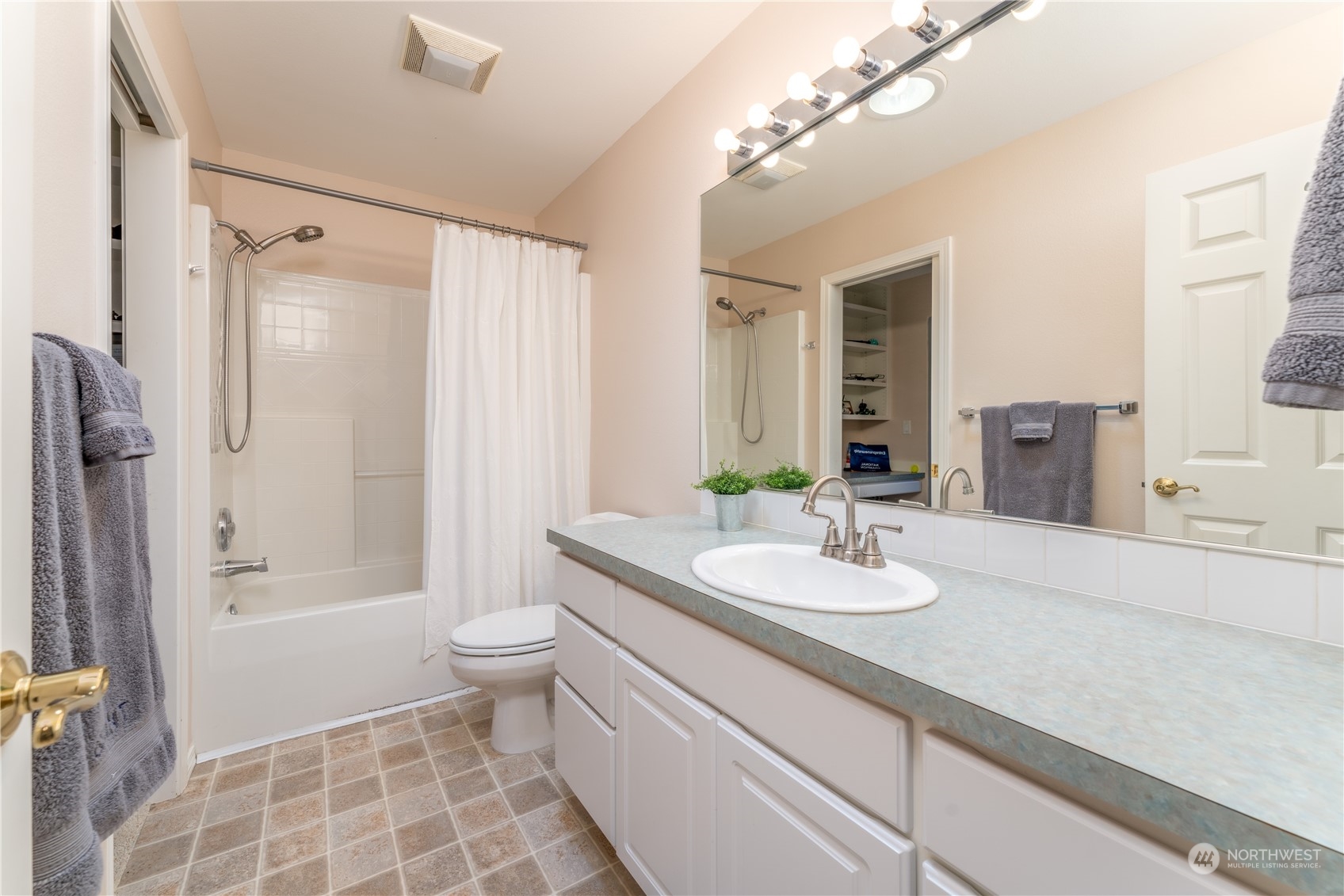 900 Loop Avenue Manson, WA 98831 - Photo 35 of 40 a bathroom with a granite countertop sink a toilet a mirror and shower