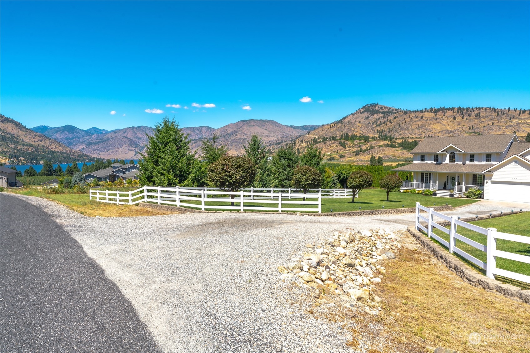 900 Loop Avenue Manson, WA 98831 - Photo 8 of 40 a view of a house with a yard and a large tree