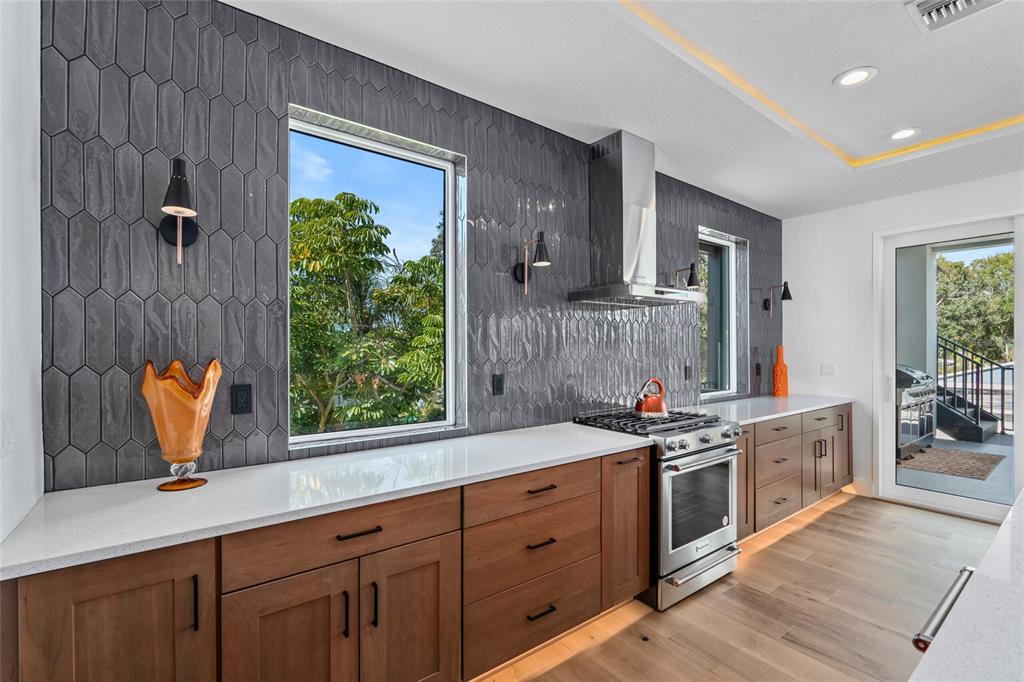 3 Plainview Road, Unit LOT 3 Odessa, FL 33556 - Photo 4 of 9 a kitchen with stainless steel appliances granite countertop a sink a stove and a wooden floors