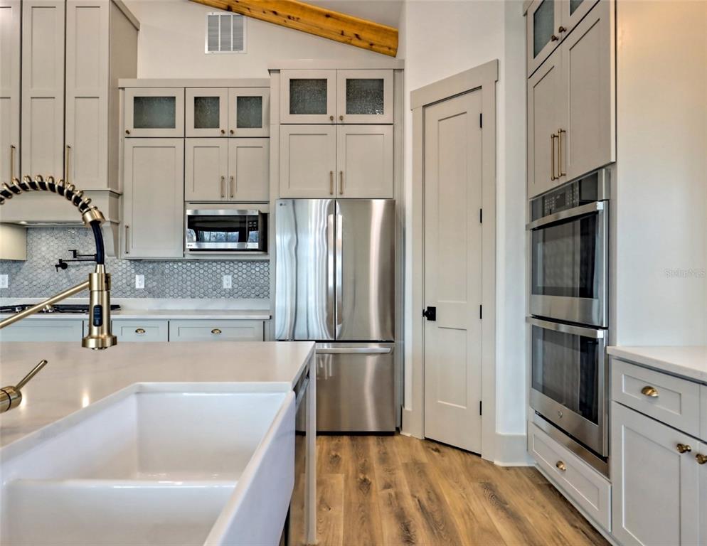 3 Plainview Road, Unit LOT 3 Odessa, FL 33556 - Photo 5 of 9 a kitchen with stainless steel appliances a refrigerator sink and microwave