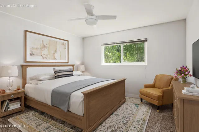 a bedroom with furniture and a window