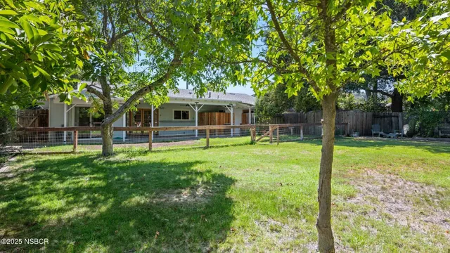 a view of a house with a backyard