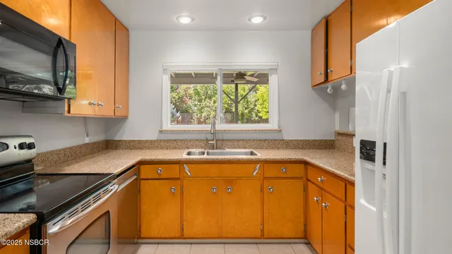 a bathroom with a granite countertop sink and a bathtub