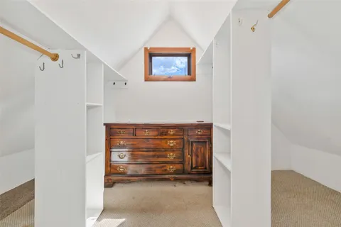 a view of hallway with wooden floor and windows
