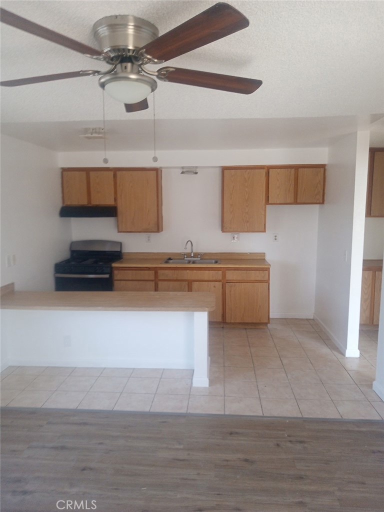 a kitchen with a cabinets and wooden floor