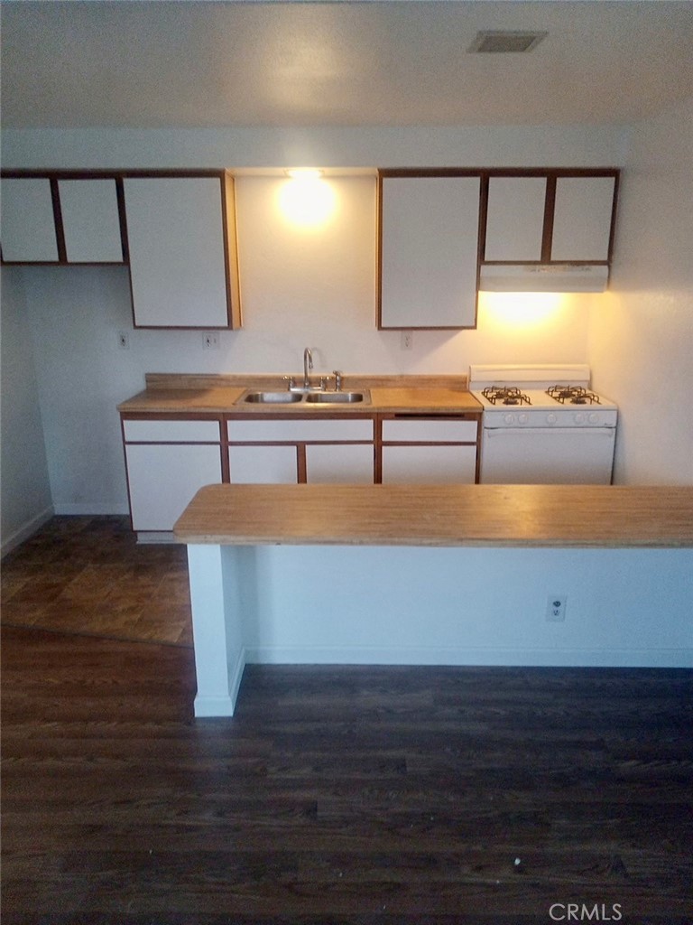 16315 Juniper Street, Unit 4 Hesperia, CA 92345 - Photo 11 of 24 a view of kitchen with wooden floor