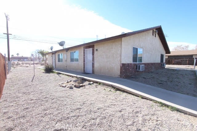 16315 Juniper Street, Unit 4 Hesperia, CA 92345 - Photo 12 of 24 a front view of a house with a yard