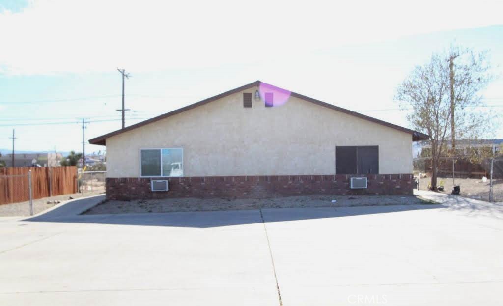 16315 Juniper Street, Unit 4 Hesperia, CA 92345 - Photo 14 of 24 a front view of a house with a yard