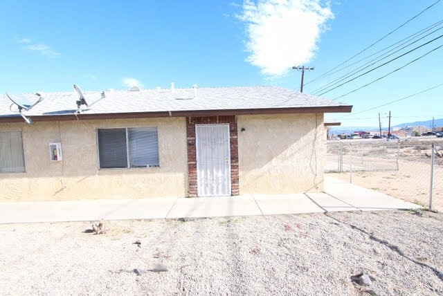16315 Juniper Street, Unit 4 Hesperia, CA 92345 - Photo 16 of 24 a front view of a house with a outdoor space