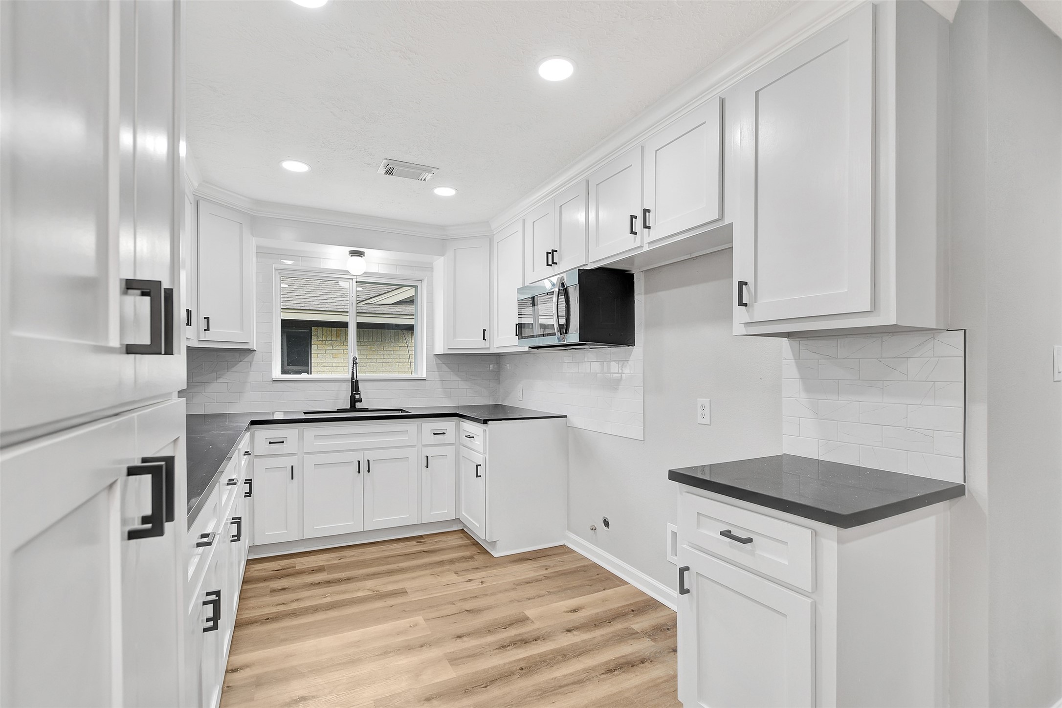 704 Teabury Street Pasadena, TX 77503 - Photo 14 of 43 a kitchen with granite countertop white cabinets and white appliances