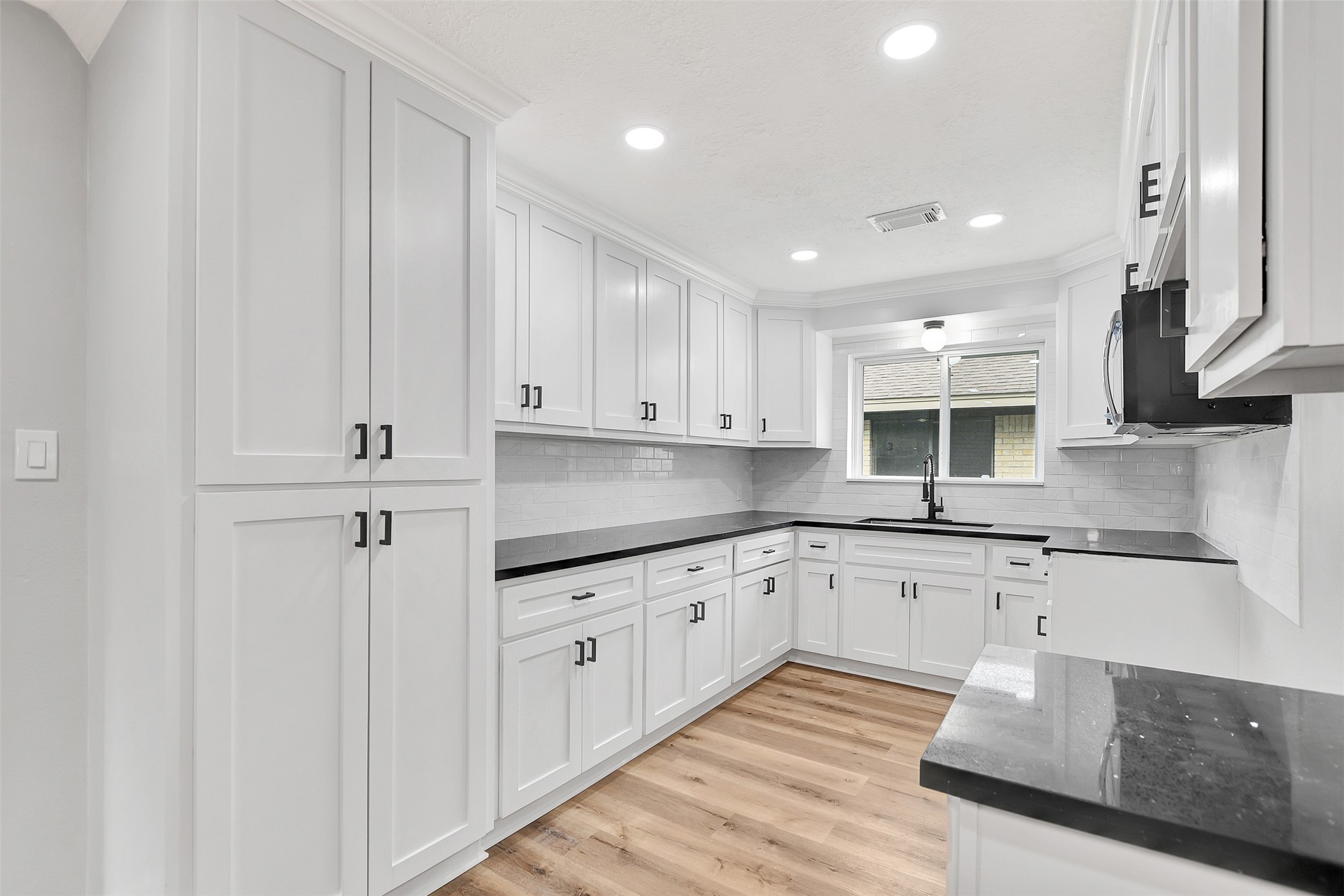 704 Teabury Street Pasadena, TX 77503 - Photo 15 of 43 a kitchen with granite countertop white cabinets and white appliances