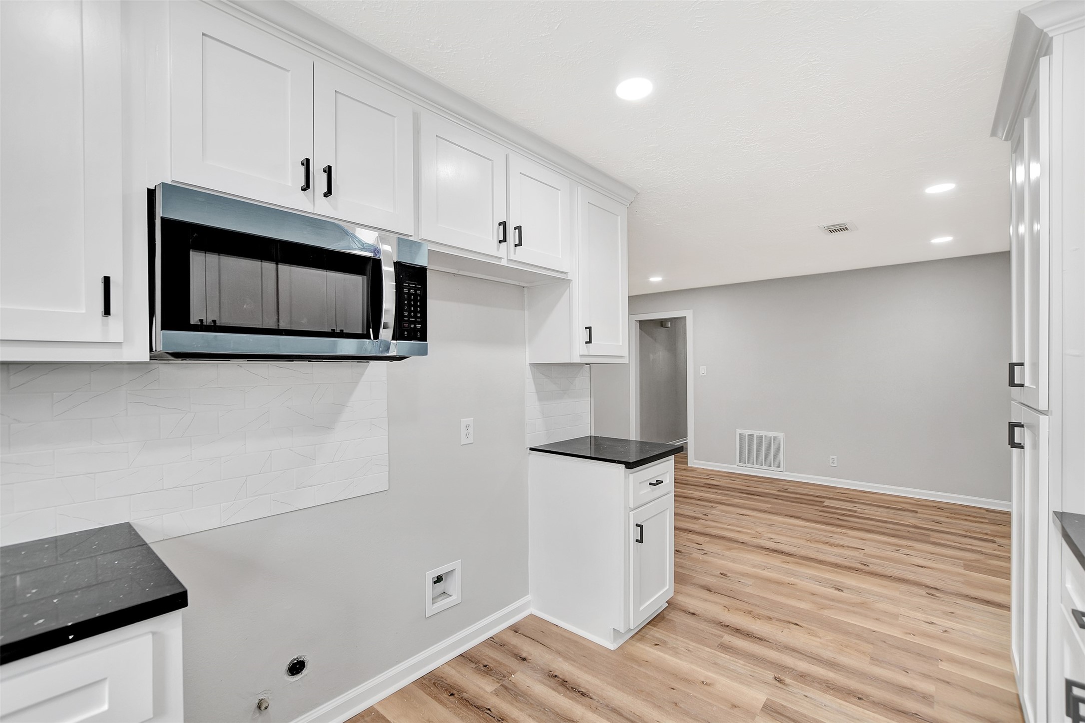 704 Teabury Street Pasadena, TX 77503 - Photo 18 of 43 a kitchen with granite countertop white cabinets and stainless steel appliances