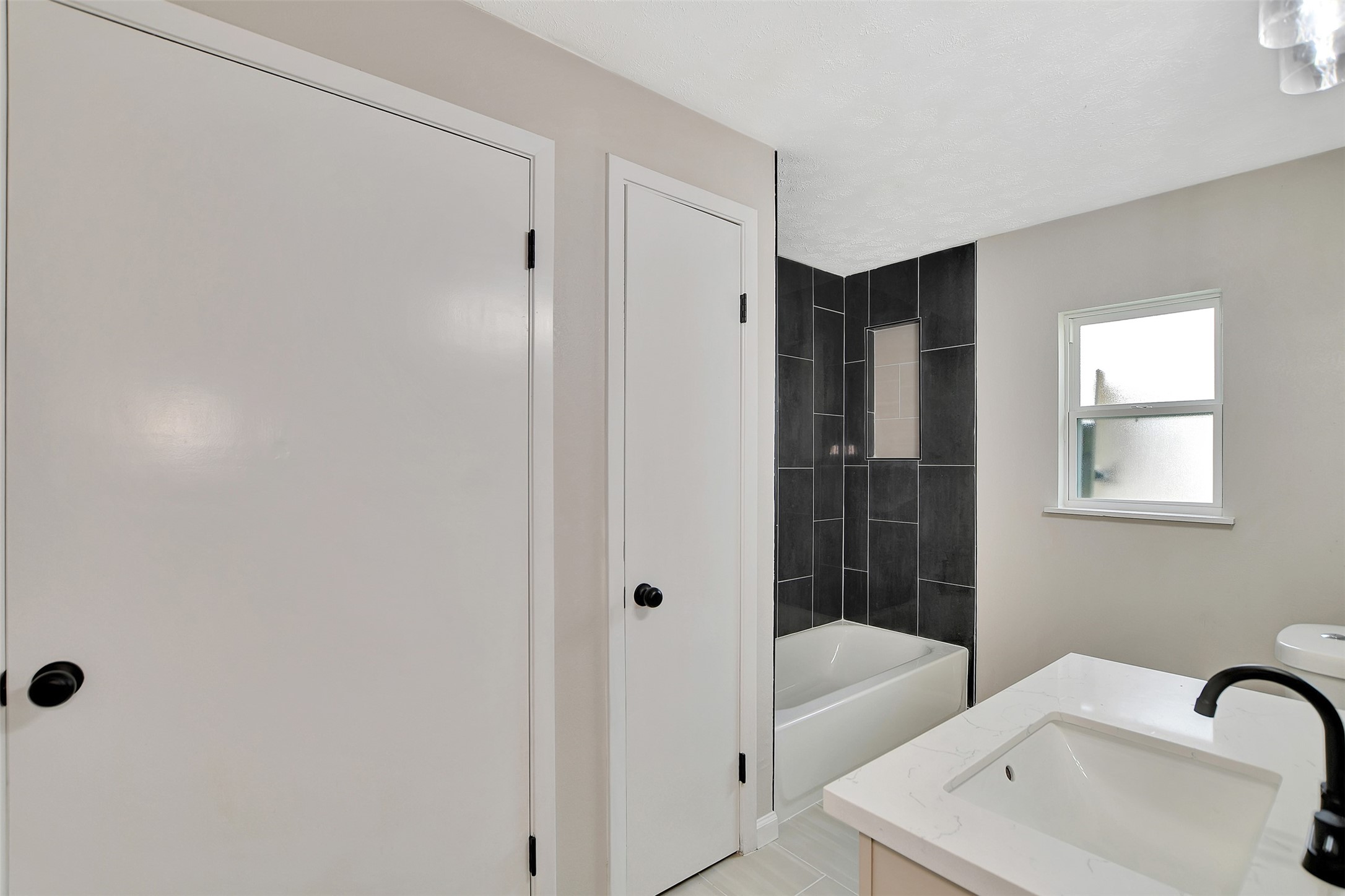 704 Teabury Street Pasadena, TX 77503 - Photo 28 of 43 a bathroom with a tub a sink a window and a shower