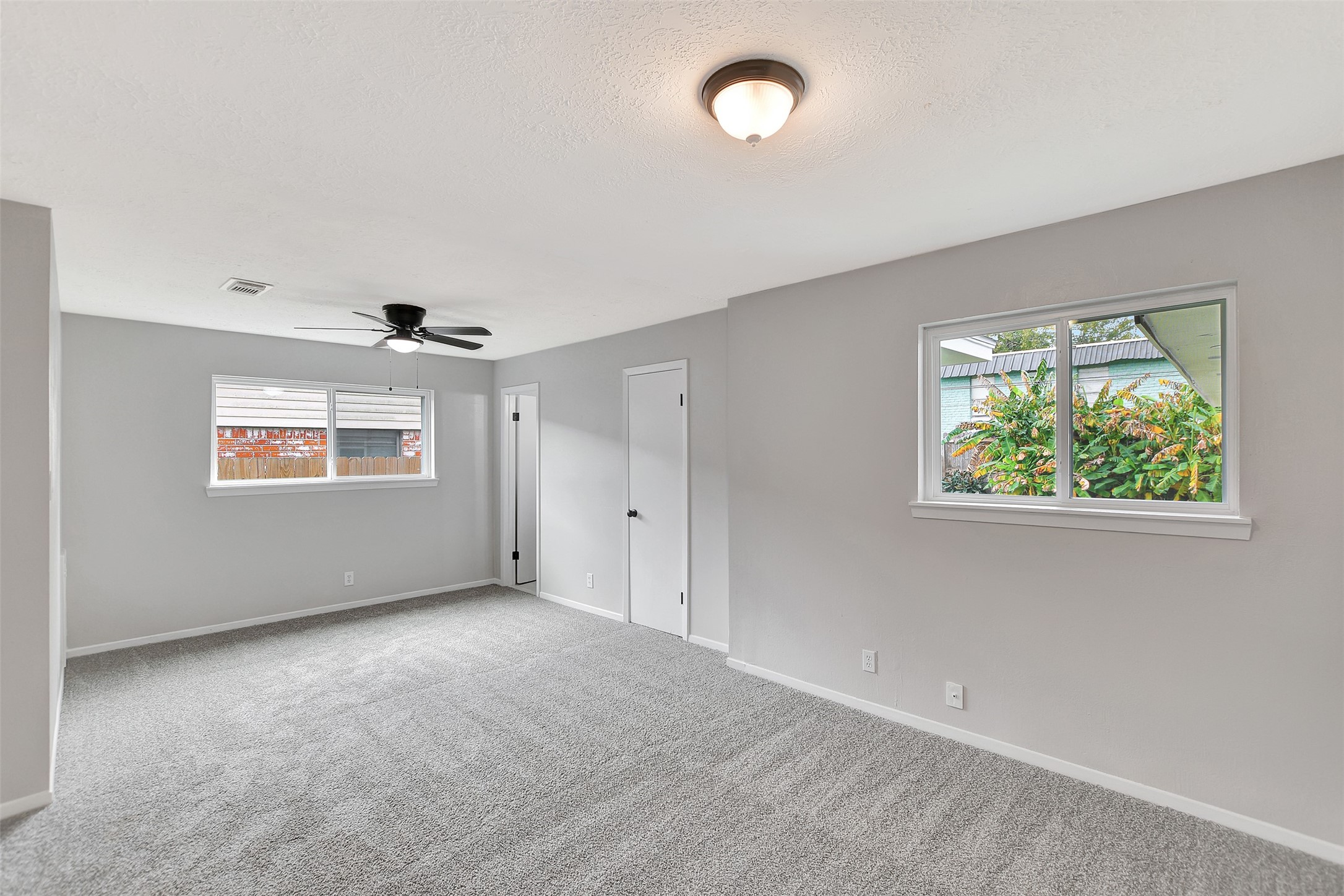 704 Teabury Street Pasadena, TX 77503 - Photo 32 of 43 an empty room with windows and painted walls
