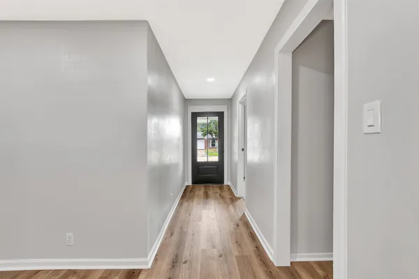 a view of hallway with wooden floor