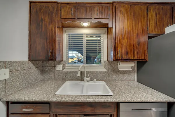 a view of a kitchen with refrigerator and stove
