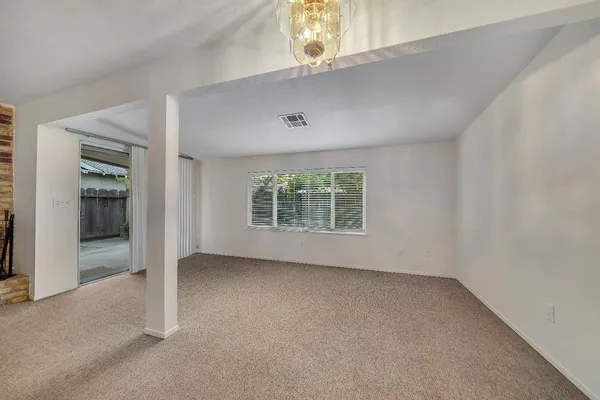 a view of an empty room with a kitchen