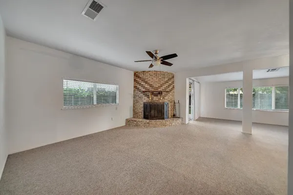 a view of an empty room with a fireplace