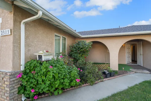a front view of house with flowers