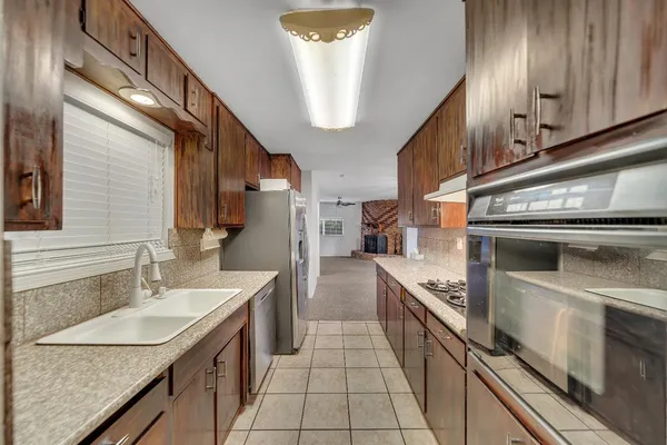 a kitchen with stainless steel appliances granite countertop a stove and a refrigerator