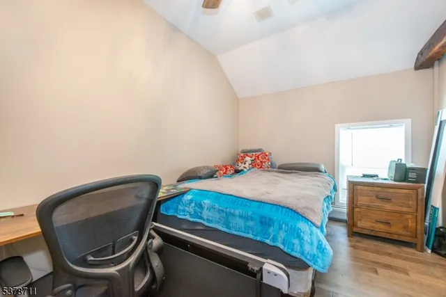 a bedroom with a chair and a dresser