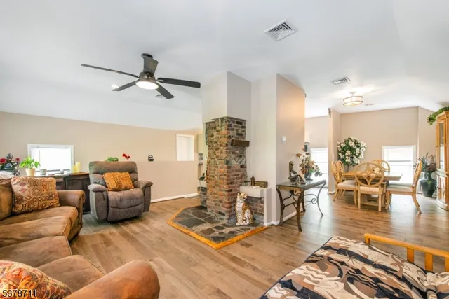 a living room with furniture and wooden floor