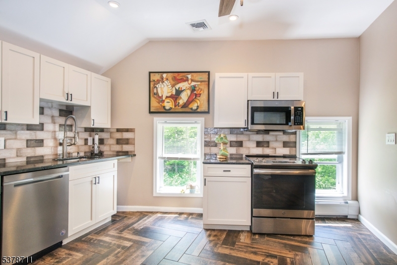 1856 Rt565, Unit 1 Glenwood, NJ 07418 - Photo 8 of 20 a kitchen with stainless steel appliances a stove a sink and a microwave