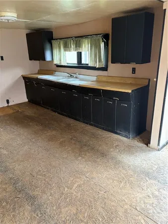 a spacious bathroom with a granite countertop sink and a mirror