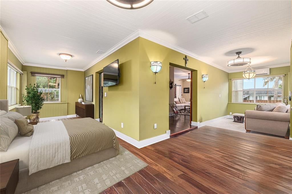 44 Southeast 8th Court Ocala, FL 34471 - Photo 20 of 87 a spacious bedroom with a large bed and a couch