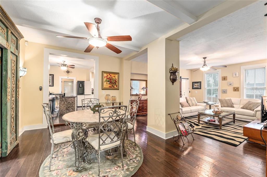 44 Southeast 8th Court Ocala, FL 34471 - Photo 22 of 87 a dining room with wooden floor a chandelier fan a wooden table and chairs