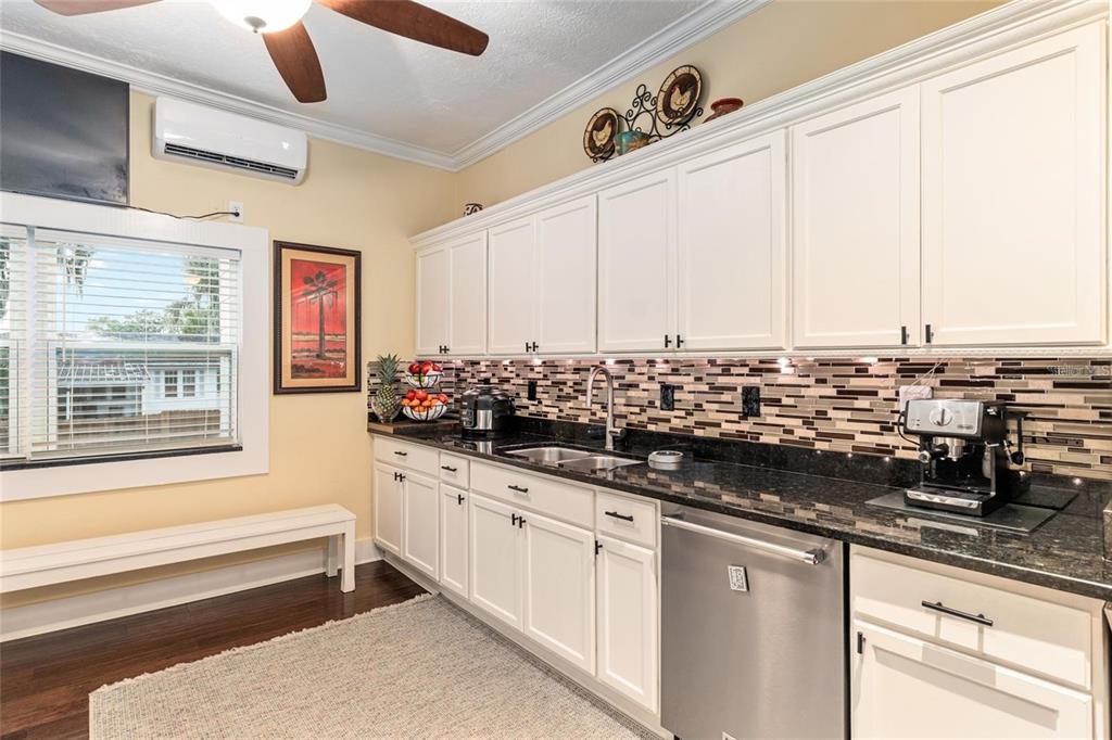 44 Southeast 8th Court Ocala, FL 34471 - Photo 38 of 87 a kitchen with stainless steel appliances granite countertop a sink and a white cabinets
