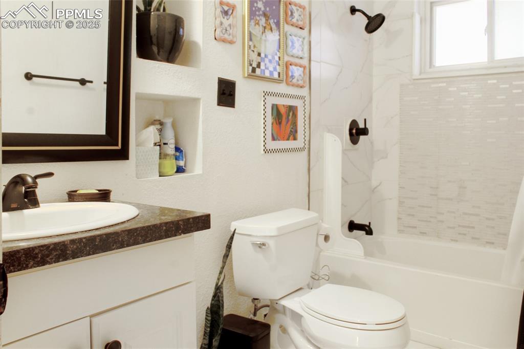 609 Placid Road Colorado Springs, CO 80910 - Photo 11 of 28 a bathroom with a sink toilet and shower