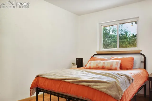 a bedroom with a bed and flowerpot