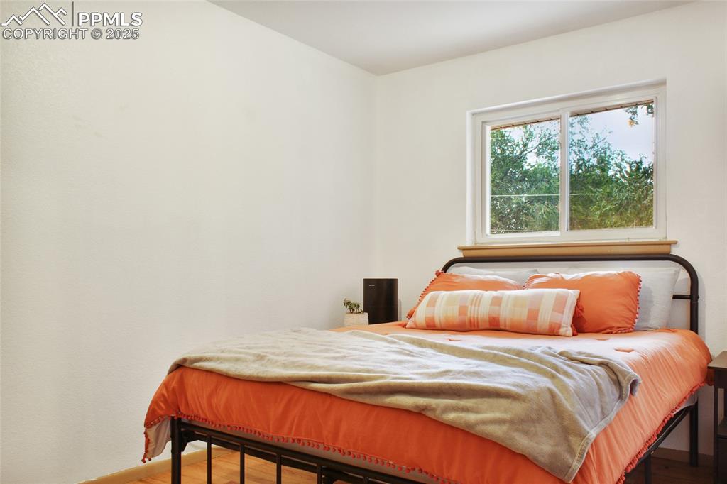 609 Placid Road Colorado Springs, CO 80910 - Photo 12 of 28 a bedroom with a bed and a window